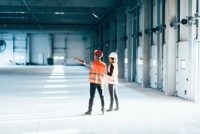 Facility management staff inspecting building