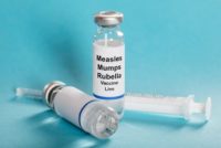 Measles vaccine vials and syringe