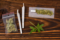 Marijuana (cannabis) buds and joints on a desk